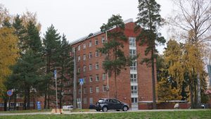 a car is parked in front of a brick building